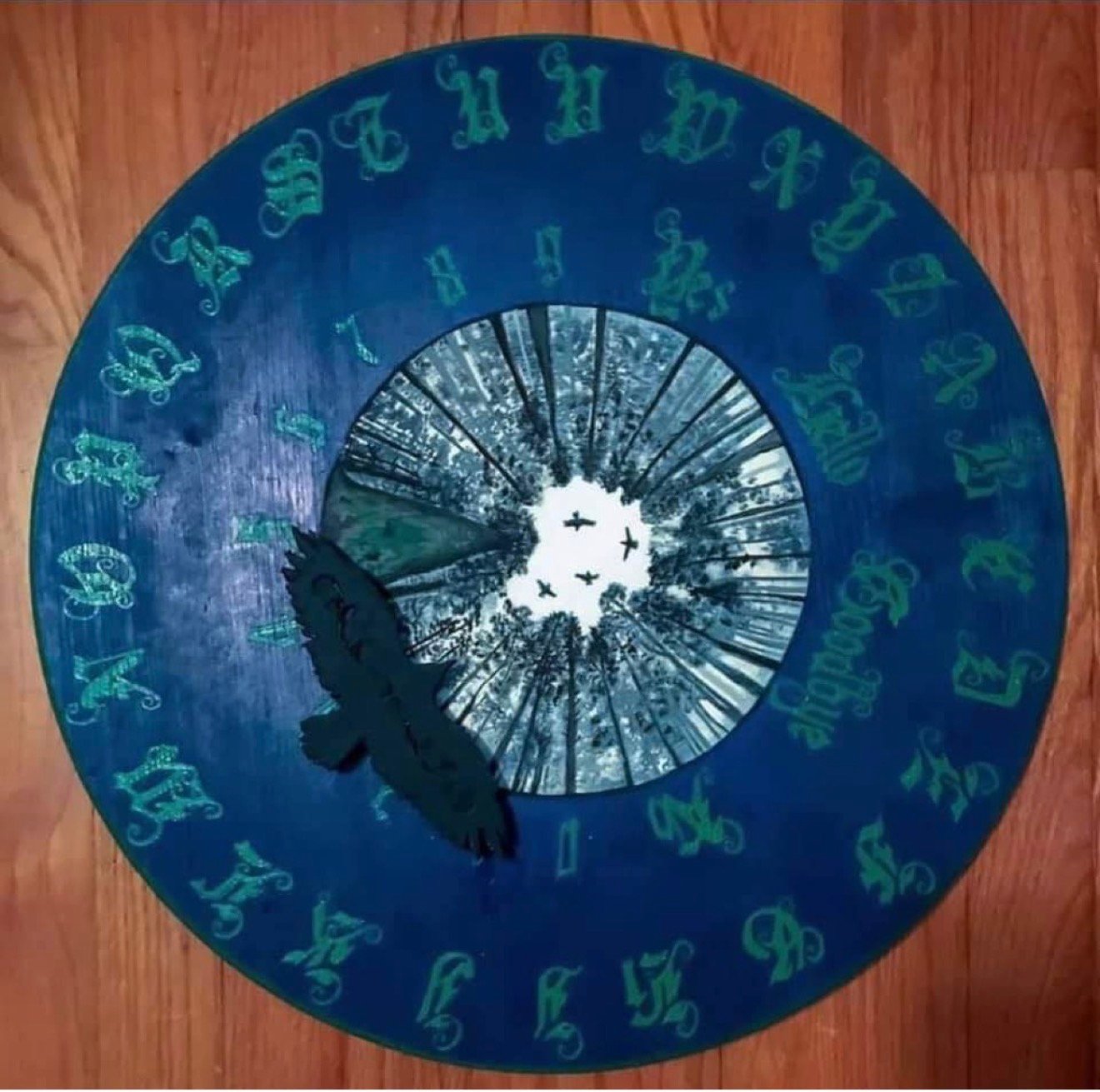 Hand-painted round spirit board with raven and forest canopy by Loren Morris, Primitive Witchery